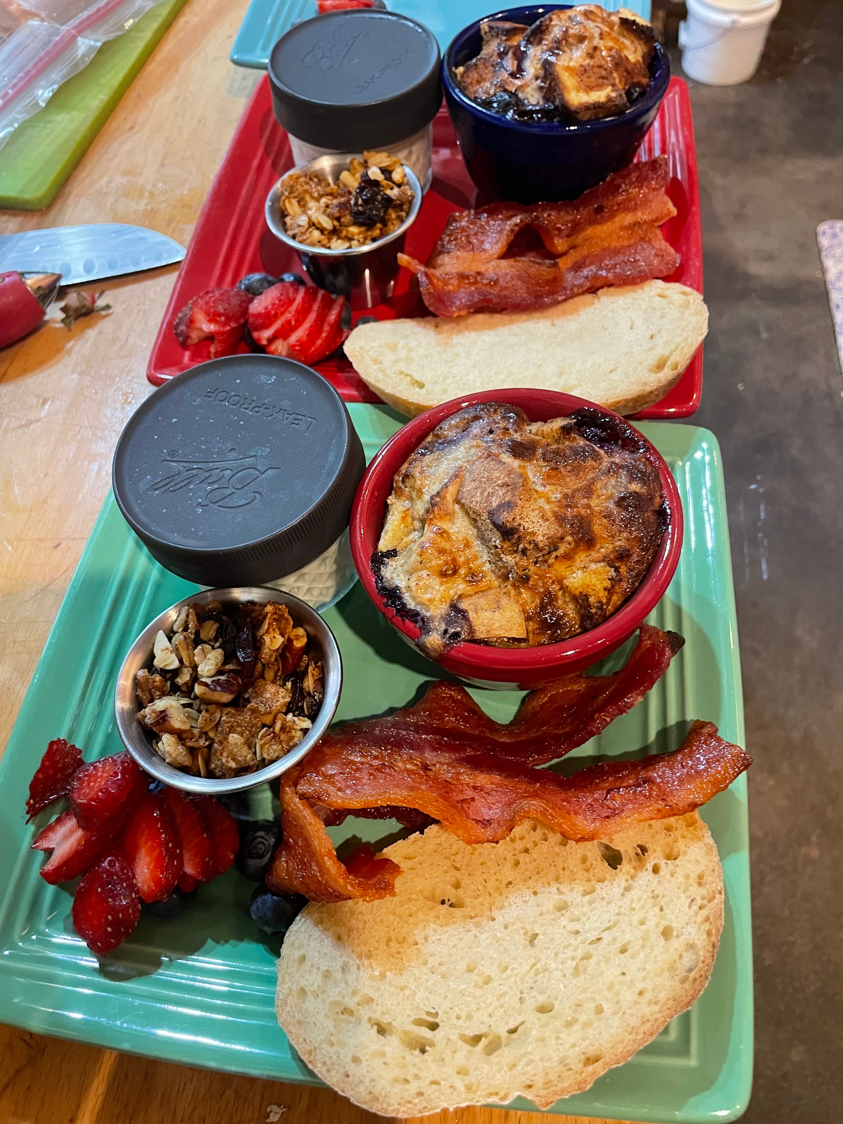 Breakfast trays with bacon, bread, granola and berries